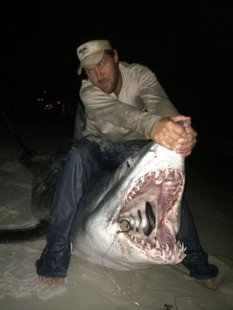 Joey Polk with shark on beach