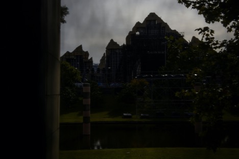 The back side of one of the stages from the 2021 Astroworld Festival is seen through a tarp near a makeshift memorial for the concertgoers who died in a stampede during a Travis Scott performance in Houston, Texas, U.S.